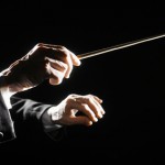 Orchestra conductor hands baton